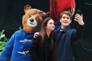 Samuel Joslin with Madeleine Harris in "Paddington In Peru" Great Western Railway Train Unveil Photocall (Image via Getty)